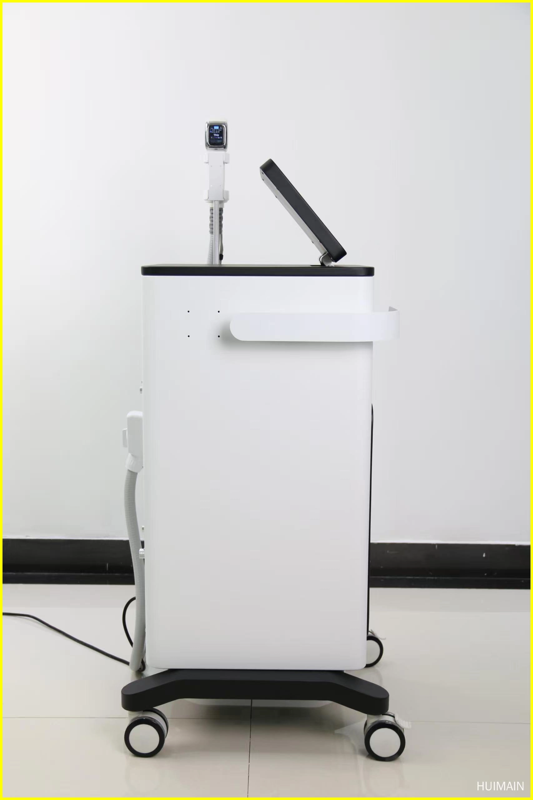 Side view of a white and black medical or aesthetic device with a touch screen and applicator. - HUIMAIN