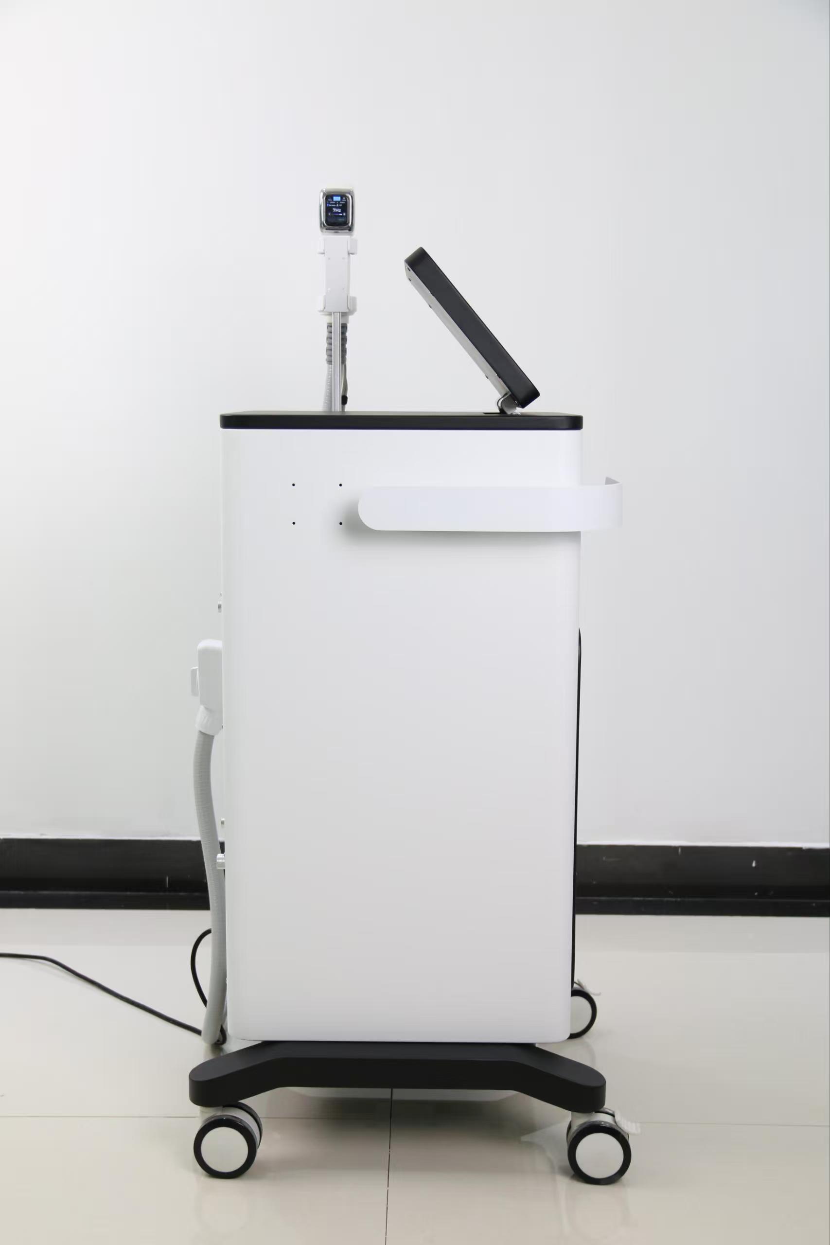 Side view of a white and black medical or aesthetic device with a touch screen and applicator.