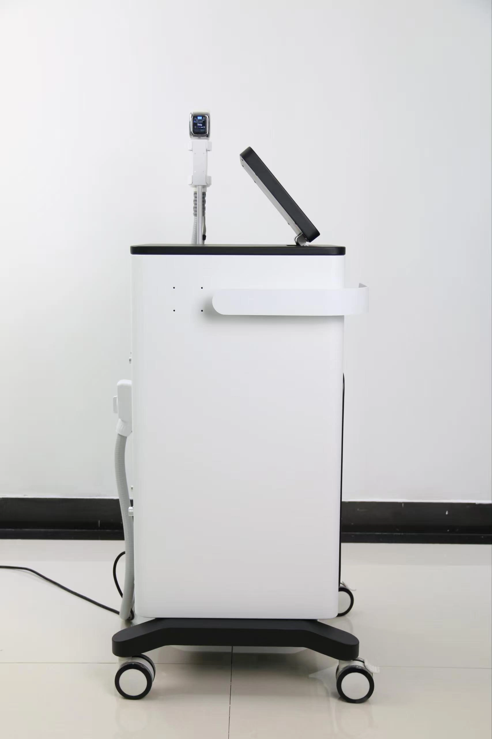 Side view of a white and black medical or aesthetic device with a touch screen and applicator. - HUIMAIN