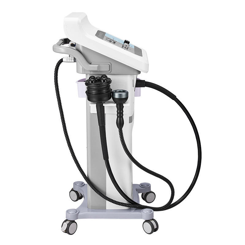 Máquina profesional para esculpir el cuerpo con múltiples accesorios sobre soporte rodante.